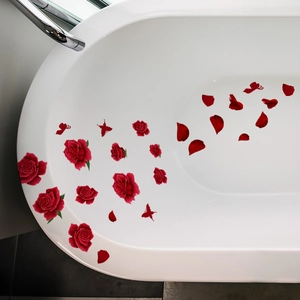 Detail of waterproof red rose and petal wall stickers applied on a white bathtub surface