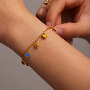 Gold stainless steel bracelet with colorful dripping oil heart pendants on a fine chain