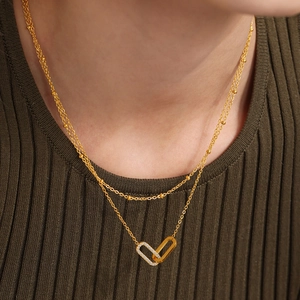 Elegant gold-tone layered necklace set with cubic zirconia interlaced rectangle pendants