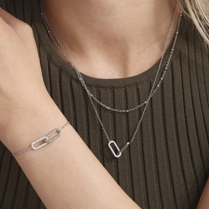 Elegant layered silver necklace and bracelet set with interlocking zircon pendant rings