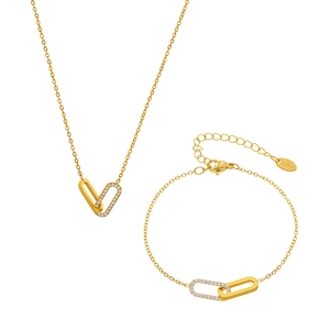 Golden stainless steel jewelry set with geometric interlocking rings and cubic zirconia