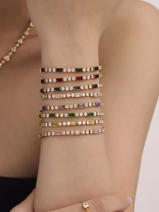 Set of eight colorful tennis bracelets with rectangular zircon in a gold finish on wrist