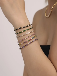 Dettaglio di bracciali colorati in zircone e acciaio inossidabile placcato in oro