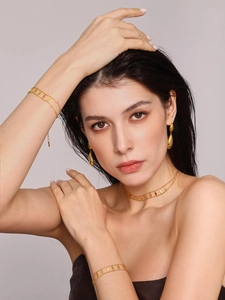 Detail of minimalist 18K gold plated jewelry set featuring diamond sequin pendants