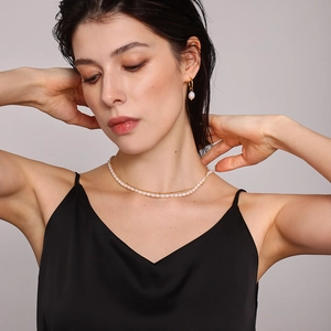 Double-layer natural freshwater pearl necklace and gold earrings on a model