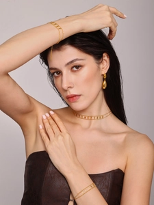 Close-up of gold stainless steel choker and bracelet set with diamond-shaped sequins