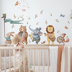 Detailed view of cartoon animal orchestra wall stickers applied in a bright nursery setting