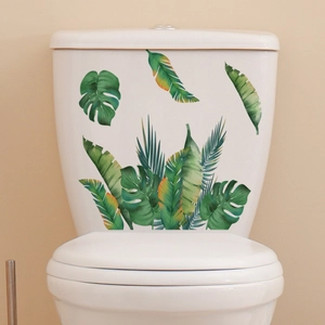 Tropical green palm leaves and monstera wall stickers on a white toilet tank