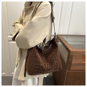 Close-up of leopard print tote bag in dark brown faux suede with slim shoulder straps