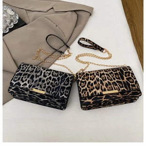 Detail of leopard print chain bags with gold metal clasps and textured faux fur finish