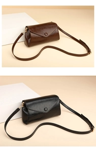 Detail view of vintage minimalist shoulder bags in dark brown and black leather with round button