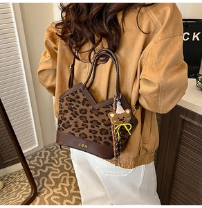 Detail of leopard print suede tote with JDH logo and cute brown bear pendant accessory