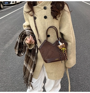 Close-up of deep brown leopard pattern tote with V-cut opening and cute bear charm pendant