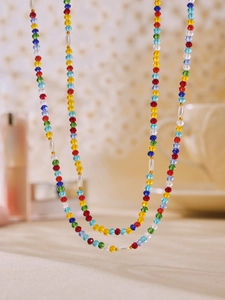Detail of colorful faceted crystal beads and white pearls on a handcrafted necklace