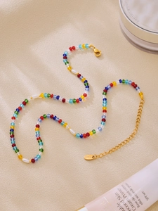 Detailed macro view of multi-colored beaded necklace with stainless steel extension chain