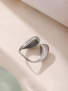Macro shot of silver irregular teardrop ring with a polished metallic mirror finish