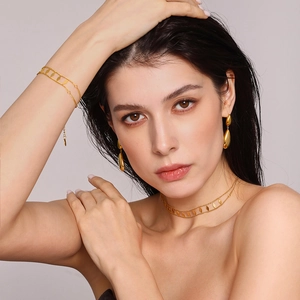 Double-layered gold rhombic sequin necklace set with matching bracelet and teardrop earrings