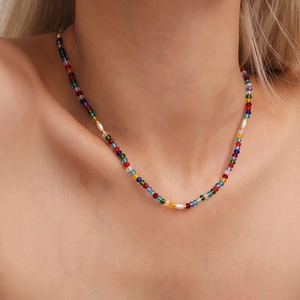 Colorful beaded necklace with faceted crystal stones and imitation pearls on model