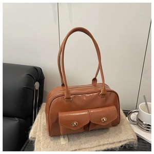 Détail du sac vintage marron caramel en cuir ciré avec deux poches et fermoirs pivotants