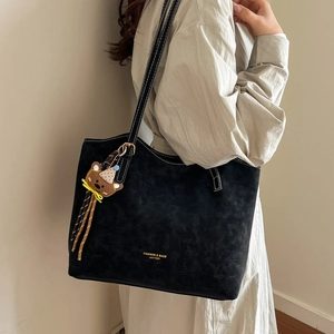 Large capacity black tote bag with white contrast stitching and cute bear charm pendant