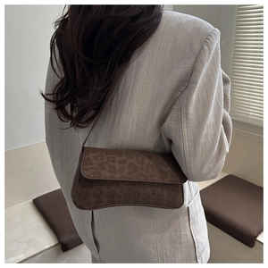 Chic leopard print faux suede shoulder bag with rectangular flap design shown on model