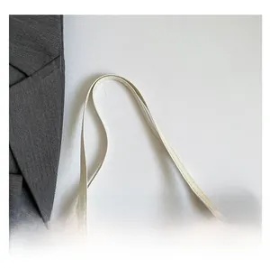 Close-up of comfortable faux leather handles and cherry print on white tote bag