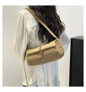 Khaki crossbody bag featuring dual flap pockets and an adjustable shoulder strap design