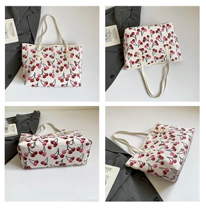 Detail view of large cherry print tote bag showing front, side, and bottom canvas panels