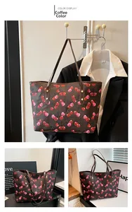 Detail view of coffee tote bag featuring cherry print and cross-grain leather texture