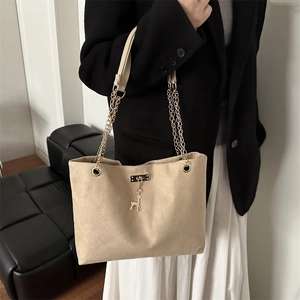 Sac fourre-tout rétro kaki avec chaîne et pendentif cerf porté par un mannequin