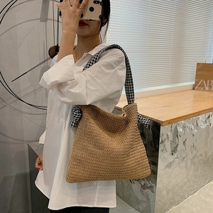 Handmade straw tote bag with houndstooth strap for summer vacation and beach use