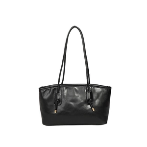 Classic black faux leather tote bag with long straps and gold metal accents on white background