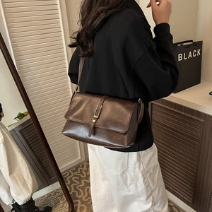 Retro deep brown leather crossbody bag with vintage metal buckle for casual work styling