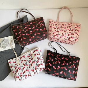Fashion cherry print tote bags in four colors shown from a top-down creative view