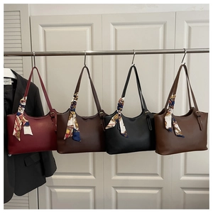Detail of four colorful vintage tote bags with floral silk scarves on handles