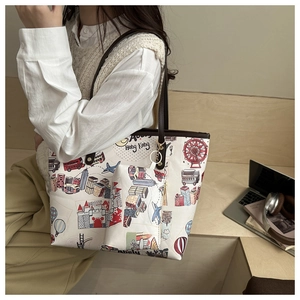 Detail of travel print tote bag with mini pouch set and brown shoulder strap