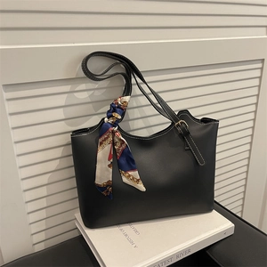 Retro black leather tote bag with white contrast stitching and floral silk scarf detail