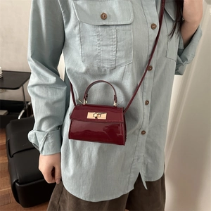 Burgundy patent leather mini crossbody bag with gold twist lock and top handle