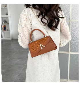 Détail du sac bandoulière marron caramel avec broderie géométrique et boucle dorée