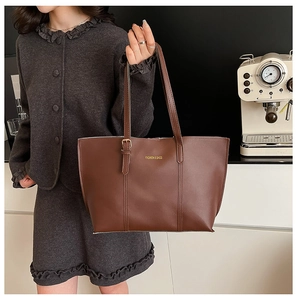 Brown leather tote bag featuring golden Fashion & Bags text and decorative buckle detail