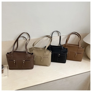 Detail view of stylish minimalist tote bags in coffee, beige, black, and brown colors