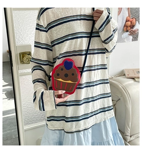 Detail of creative cupcake shaped crossbody bag with colorful stitching and heart design