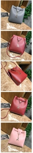Detailed close-up of mini bucket crossbody bags with golden deer charms in three colors