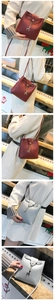 Close-up of mini bucket bag in wine red and grey-blue with metal deer pendant