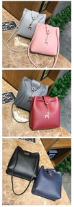Detail view of mini PU leather drawstring bucket bag with gold deer charm decoration