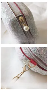 Detail of silver sequin bag with gold hardware, pearl zipper pull and detachable chain buckle