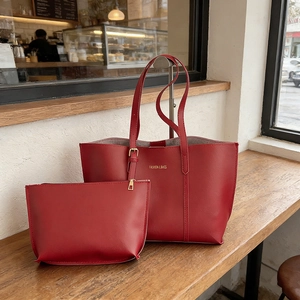 Large red leather tote bag set with small matching pouch and gold metal hardware