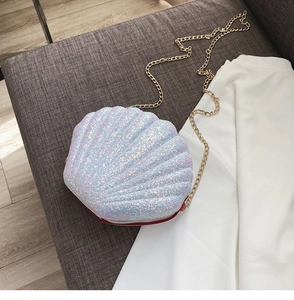 Detailed close-up of shell-shaped crossbody bag with white iridescent sequins and gold chain
