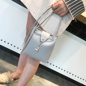 Mini deer-pendant bucket crossbody bag in light blue-grey leather with drawstring detail