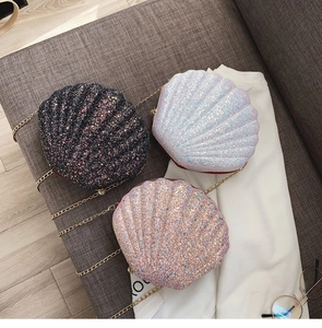Detail of shell-shaped crossbody bags with glitter sequins and gold chain straps